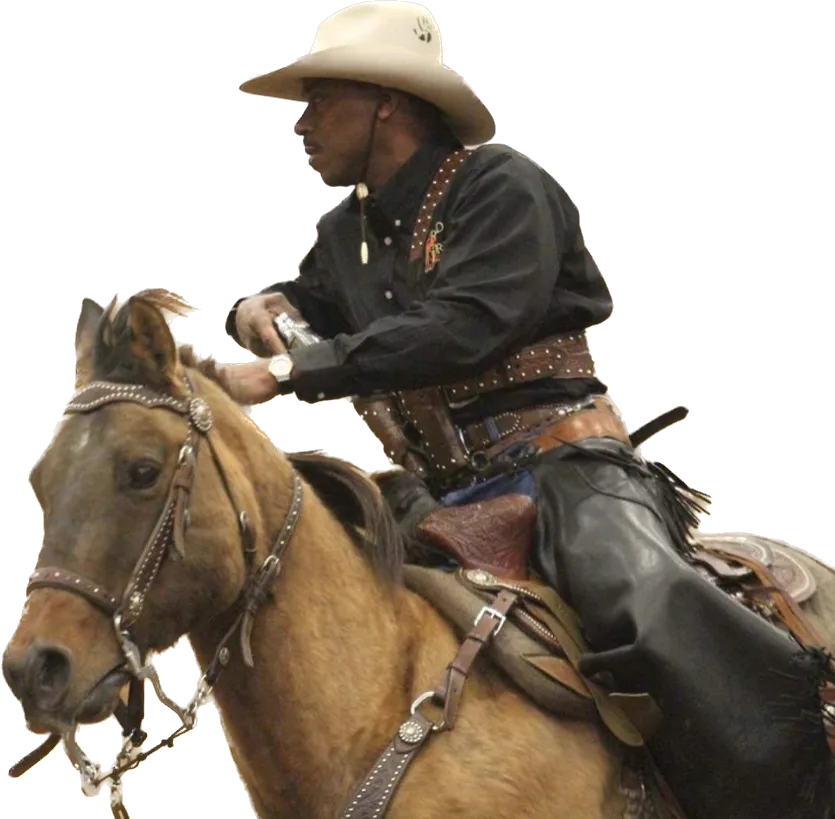 Coach Ricardo Patton riding a horse in a cowboy hat